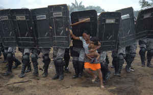 Woman tries to stop forced eviction of her people, Manaus, Brazil, March 10